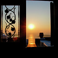 Sunset in the aegean sea from a house. Santorini island Greece.